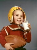 Buy 1950s 1960s Boy Drinking Glass Milk Wearing Football Helmet Shoulder Pads at AllPosters.com