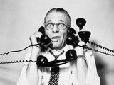 1950s 1960s Portrait Of Frazzled Businessman Trying To Answer Four Black Telephones Phones At Once
