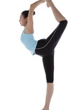 Female gymnast standing on one leg, holding other foot behind her head