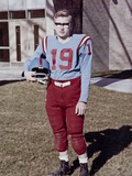 Fifteen year old high school football player portrait outside the school, ca. 1961