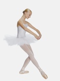 Young ballerina (14-15) standing on pointe in toe shoes,, portrait