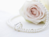 Necklace, wedding rings and flower