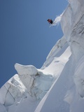 Back country skier jumping off mountain