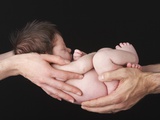Baby Girl Cradled in Parents