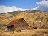 The famous Steamboat Barn, Steamboat Springs Ski Area in the background with yellow aspen trees, Co