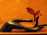 Sculpted Hand Holding Massage Oil Vial