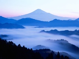 Distant view of Mount Fuji silhouetted against blue sky