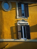 Shuttered Windows on Yellow Building