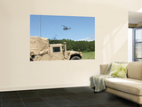 Buy A Uh-1N Helicopter Flies over the Marine Air Support Squadron Compound at AllPosters.com