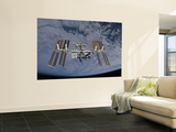 Buy International Space Station Set Against the Background of a Cloud Covered Earth at AllPosters.com