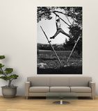 Kenneth Merriman Swinging on Tree Limb After Kicking Away Stilts