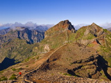 Hiker Walking Across the Volcanic Landscape Towards Madeira's Third Highest Peak, Portugal