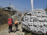 Trekkers Walking Past a Mani Stone, Solu Khumbu Everest Region, Sagarmatha National Park, Nepal