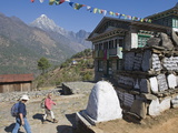 Trekkers Walking Past a Mani Stone, Solu Khumbu Everest Region, Sagarmatha National Park, Nepal