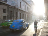 Buy Street Scene Bathed in Early Morning Sunlight Showing Old American Cars and Cyclists, Havana, Cuba at AllPosters.com