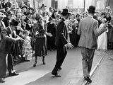 Men dancing in the street as revelers celebrate New Orleans Mardi Gras. February 1938