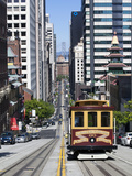Cable Car Crossing California Street with Bay Bridge Backdrop in San Francisco, California, United 