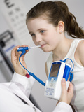 Pediatrician Examining a Girl and Taking Her Temperature