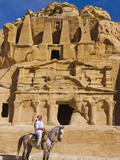 Man Riding on Horse with the Tomb of Obelisks, Petra, Jordan