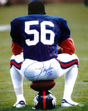 Lawrence Taylor Sitting on Football and Helmet Autographed Photo (Hand Signed Collectable)