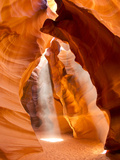 Sunlight Streams Through Cracks in a Slot Canyon Photographic Print