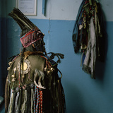 A Tuvan Shaman in Her Ceremonial Headdress and Coat