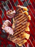 Sirloin Steak with Onions on a Barbecue