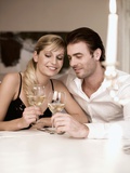 Young Couple Clinking Glasses of White Wine