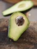 Avocado, Halved, on Old Chopping Board
