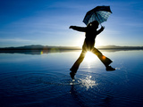A Young Woman Running and Jumping on a Salt Flats at Sunrise