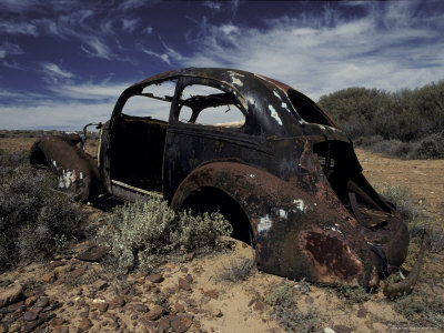 Burnt Out Antique Car Wreck Discarded to Rust Away in the Desert 
