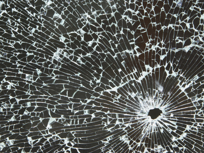 Closeup of a Hole in Cracked and Shattered Glass Photographic Print