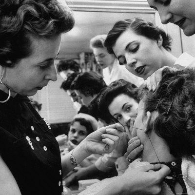 Woman on Woman Piercing Another Woman S Ears As Friends Look On Photographic