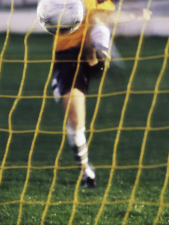 Soccer Player Kicking a Soccer Ball Photographic Print Soccer Player Kicking a Soccer Ball Photographic Print