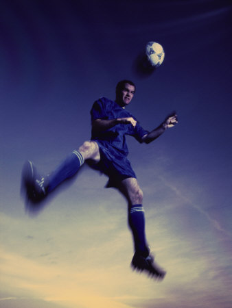 Low Section View of a Soccer Player Jumping in Mid Air to Head a Soccer Ball Photographic Print Low Section View of a Soccer Player Jumping in Mid Air to Head a Soccer Ball Photographic Print