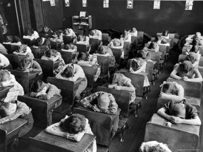 Children Desks on Elementary School Children With Heads Down On Desk During Rest Period