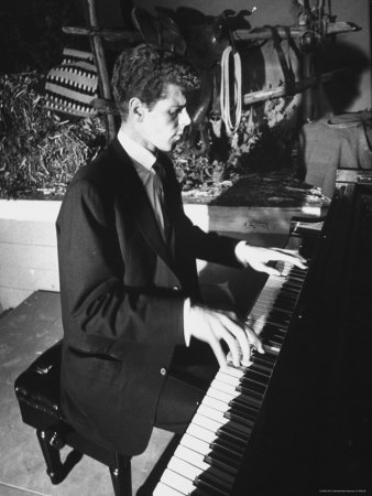 black and white photograph of pianist Van Cliburn playing a grand piano