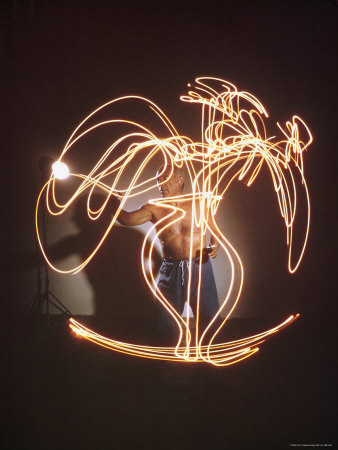Shirtless Artist Pablo Picasso Creating Light Drawing of Vase of Flowers 