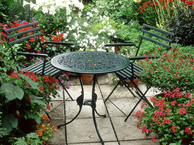 Patio Table Furniture on Metal Table And Chairs On Patio Backed By Pots With Lilium Longifolium