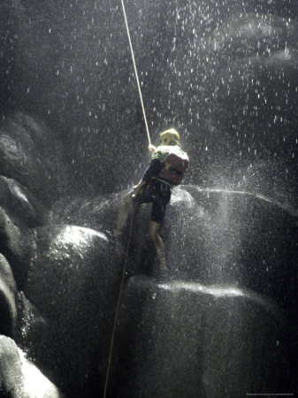 Climber Showered with Water in Cave, Mexico Premium Poster Climber Showered with Water in Cave, Mexico Premium Poster