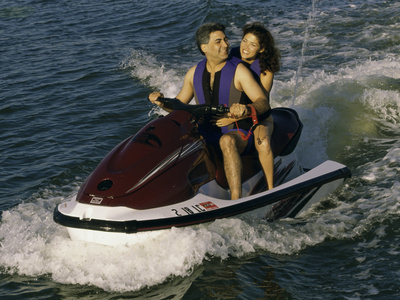 Mid Adult Couple Riding a Jet Ski Photographic Print Mid Adult Couple Riding a Jet Ski Photographic Print