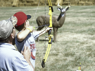 Man Teaching Boy How to Shoot an Arrow Photographic Print Man Teaching Boy How to Shoot an Arrow Photographic Print