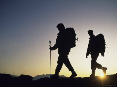 Hikers Silhouetted Against a Sunset Sky Photographic Print Hikers Silhouetted Against a Sunset Sky Photographic Print
