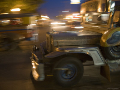 Jeepney Speeds Through Night in Malate Stretched Canvas Print
