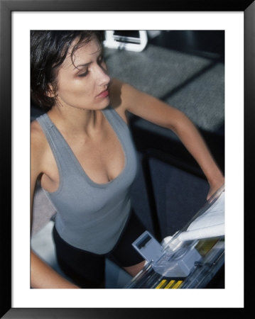 Woman on treadmill on gym Framed Print Woman on treadmill on gym Framed Print