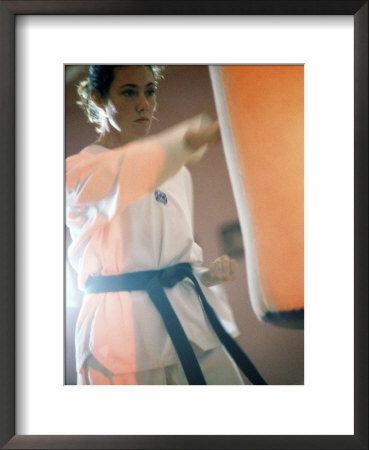 Young Woman Practicing Karate Framed Print Young Woman Practicing Karate Framed Print