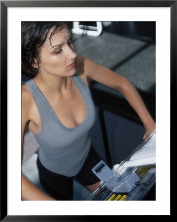 Woman on treadmill on gym Framed Print Woman on treadmill on gym Framed Print
