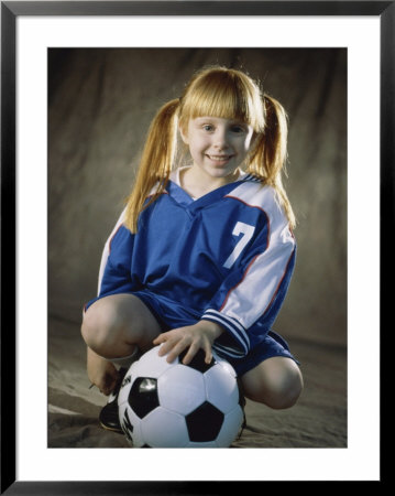 Portrait of a Girl Squatting in Front of a Soccer Ball Framed Print