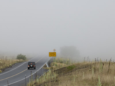 A Vehicle Slows as it Approaches a Bank of Coastal Fog with Near Zero Visibility in Hawaii Stretched Canvas Print