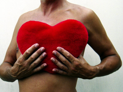 Man Holding Red Heart-Shaped Cushion in Front of His Naked Chest Stretched Canvas Print